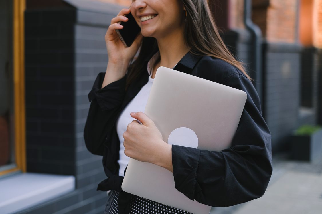 Confident woman working on her laptop while investing online